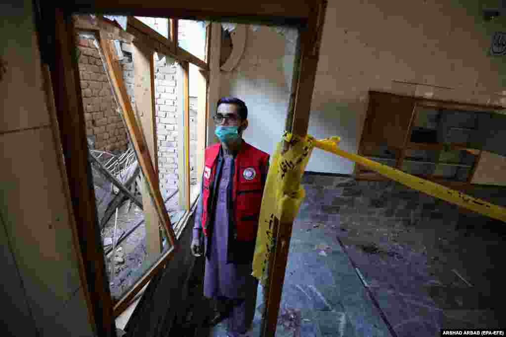 A rescue worker inspects at the Islamic seminary.