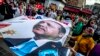 People wave a banner with a picture of Turkish President Recep Tayyip Erdogan during a gathering of supporters of his ruling Justice and Development Party (AKP) in Istanbul, Turkey, 19 June 2018