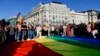 People unfurl a rainbow flag during an LGBT rights demonstration in front of the Hungarian parliament building in Budapest on June 14.