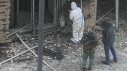 Investigators work near a scooter at the place where General Igor Kirillov and his assistant Ilya Polikarpov were killed by an explosive device planted close to a residential apartment block in Moscow on December 17.