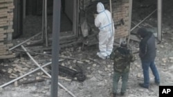 Investigators work near a scooter at the place where General Igor Kirillov and his assistant Ilya Polikarpov were killed by an explosive device planted close to a residential apartment block in Moscow on December 17.