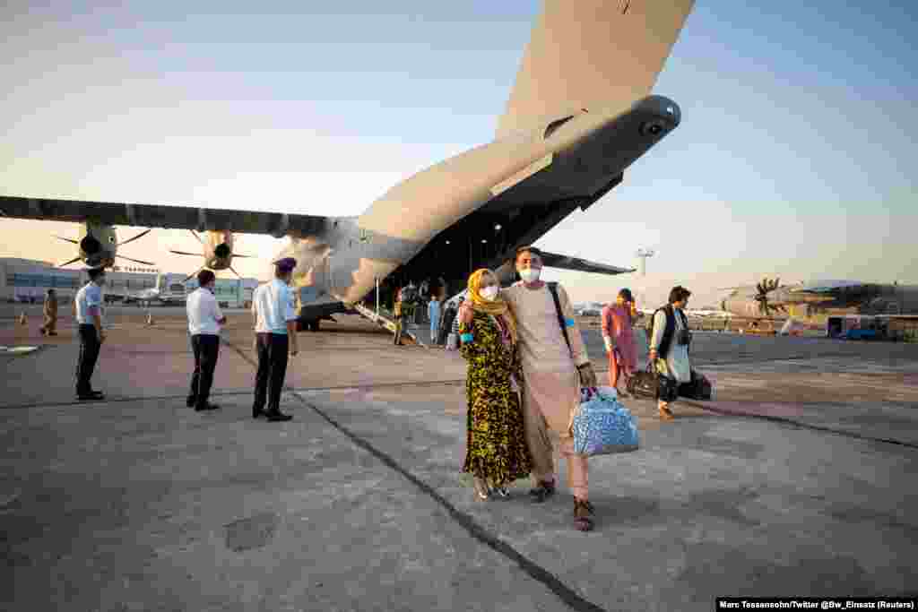 Afghan evacuees arrive in Tashkent on a German military plane.