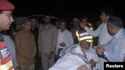 Officers and rescue workers move Pakistan's Interior Minister Ahsan Iqbal on a stretcher, after he was shot during a rally in Narowal and transported for medical attention to Lahore on May 6.