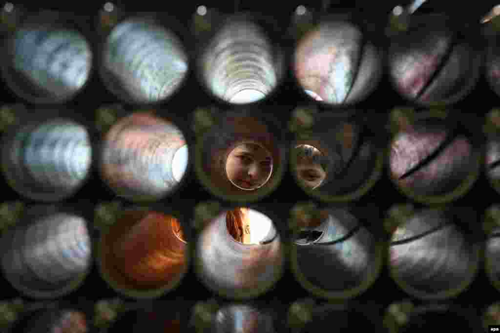 Boys look through the barrel of the multiple rocket launcher during the military parade marking the country&#39;s Independence Day in Tbilisi. (epa/Zurab Kurtsikidze)