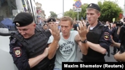 Policemen detain Russian opposition leader Aleksei Navalny in June 2019. Navalny's situation was cited leading rights groups who have slammed Moscow's "harassment and prosecution of peaceful political and civil society activists, protesters and other dissenting voices in Russia."