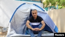 Omid Tootian, an Iranian musician, sits in a tent inside the UN buffer zone at Ledra Palace in Nicosia, Cyprus, September 27, 2020.