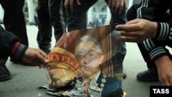 Protesters burn a portrait of ousted Kyrgyz President Kurmanbek Bakiev on the streets of Bishkek on April 8.