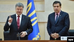 Ukrainian President Petro Poroshenko (left) presents former Georgian President Mikheil Saakashvili as the governor of Odesa on May 30, 2015.