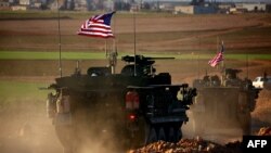 A convoy of U.S. armored vehicles drives on the western outskirts of the northern Syrian city of Manbij. (file photo)