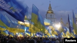 Supporters of the pro-presidential Party of Regions attend an election rally in Kyiv on October 26. The latest opinion polls give the party a slight lead over two opposition parties.