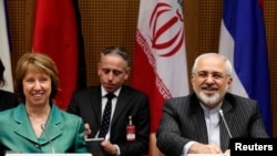 European Union foreign policy chief Catherine Ashton (left) and Iranian Foreign Minister Mohammad Javad Zarif smile at the start of a conference in Vienna on March 18.