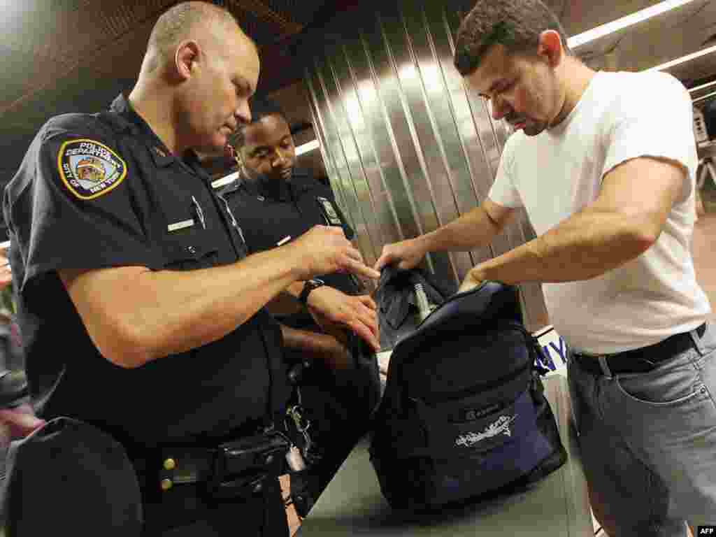 New York Police Department officers check bags during the morning commute at Grand Central Terminal in New York City.