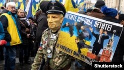 A demonstrator takes part in a rally demanding "no capitulation" to Russia in Kyiv on December 8, 2019.
