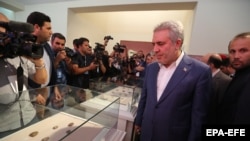 IRAN -- Iranian Minister of Cultural Heritage, Tourism, and Handicrafts Ali Asghar Munesan (R) looks at the Achaemenid-era clay tablets as are on display at Iran's National Museum in Tehran, October 2, 2019