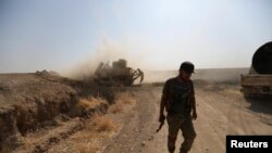 Syria - A Turkey-backed Syrian rebel fighter walks in the town of Tal Abyad.