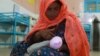 A mother feeds her child at a mobile feeding center set up by Doctors Without Borders (MSF) in Pakistan last year.