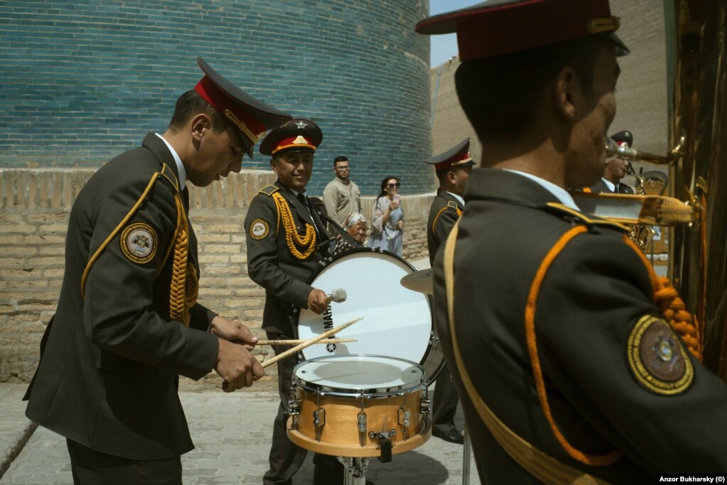 A military band performs at the base of a minaret in Khiva.