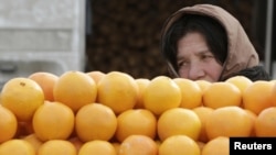 A woman sells fruit on a street market in Tbilisi.