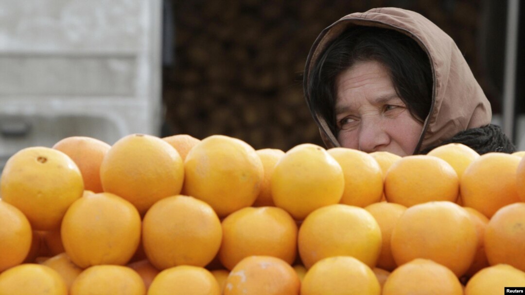 A woman sells fruit on a street market in Tbilisi.