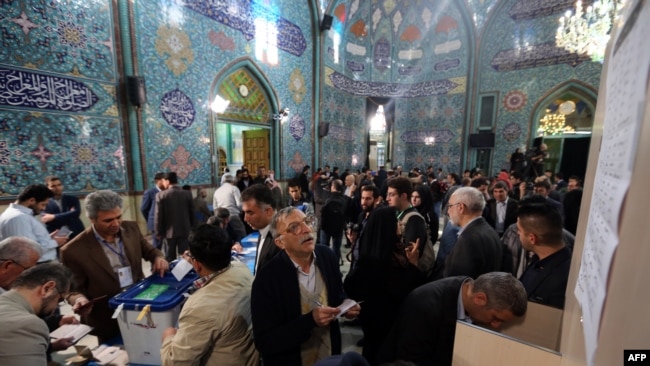 Iranians voting in February 2016 in parliamentary elections that was a defeat for conservatives but delivered little for the people.