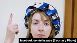 Liza Savolainen with the crown of barbed wire that she wore to her disciplinary hearing.