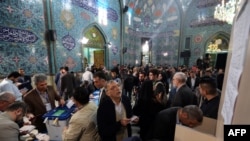 Iranian men cast their ballots at a polling station in Tehran on February 26, 2016. Like other public events, voting spaces are also gender-segregated.