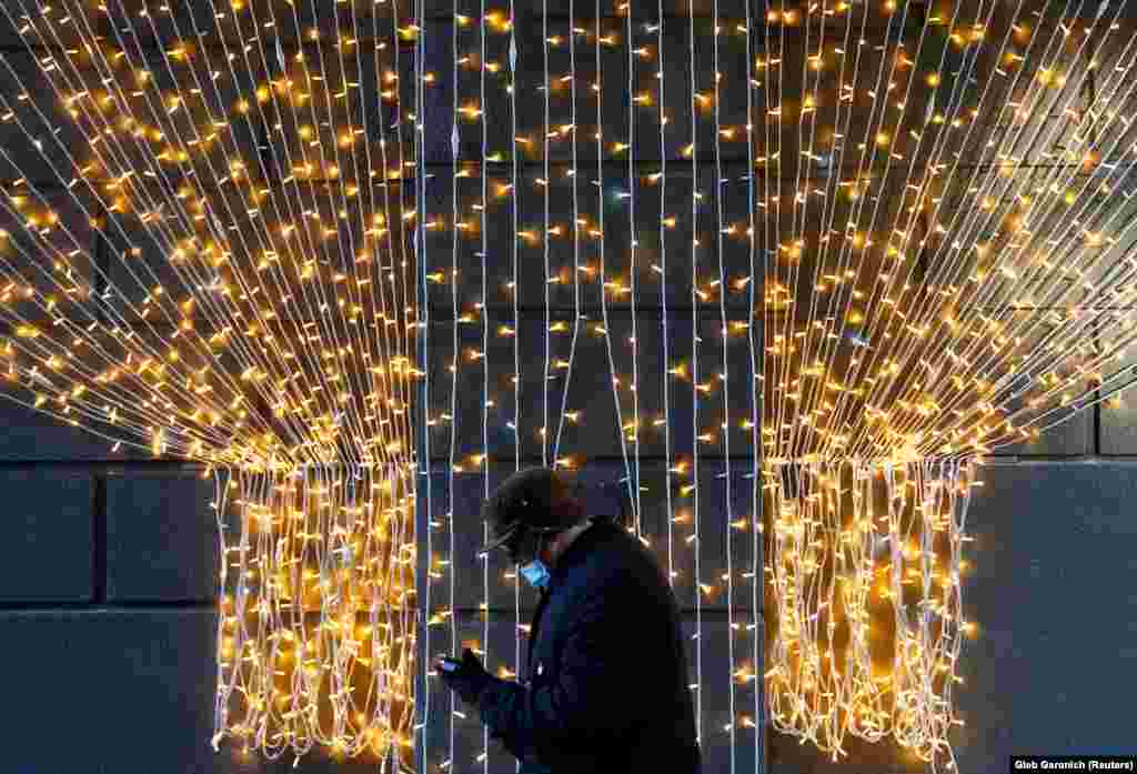 A man walks past a Christmas illumination in Kyiv. (Reuters/Gleb Garanich)