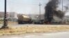 Burning vehicles belonging to Iraqi security forces are seen during clashes between Iraqi security forces and Al Qaeda-linked Islamic State in Iraq and the Levant (ISIL) in the northern Iraqi city of Mosul on June 10. 