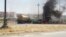 Burning vehicles belonging to Iraqi security forces are seen during clashes between Iraqi security forces and Al Qaeda-linked Islamic State in Iraq and the Levant (ISIL) in the northern Iraqi city of Mosul on June 10. 