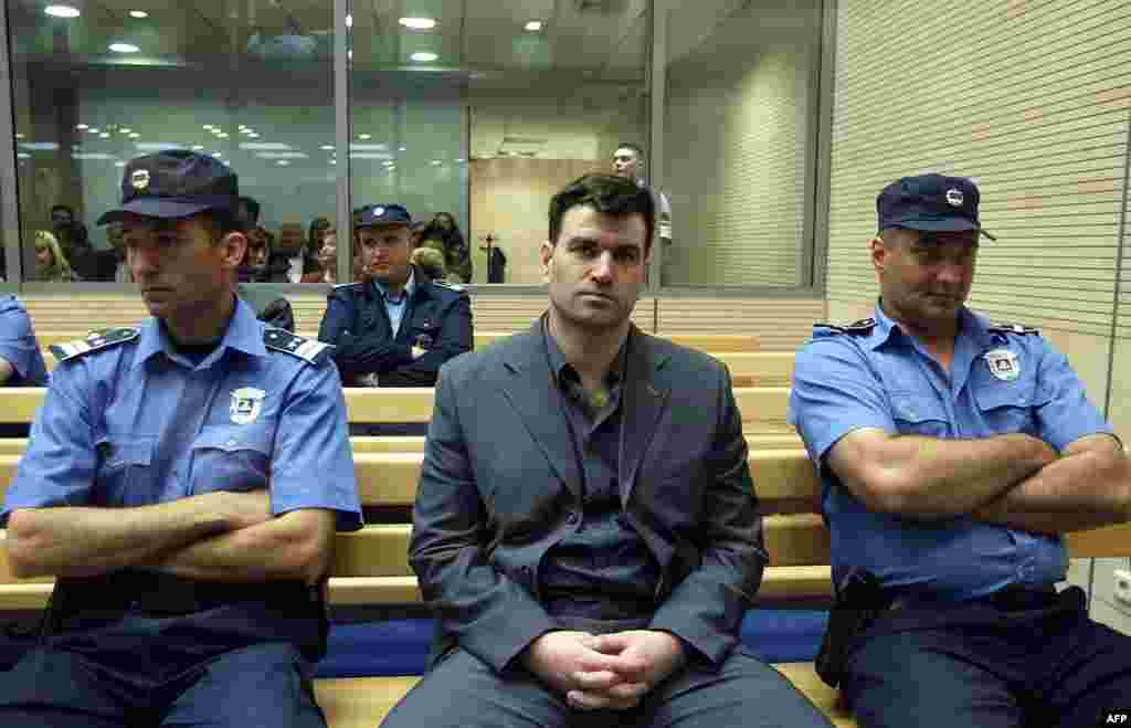 The alleged mastermind of the assassination plot, former paramilitary leader Milorad Ulemek, also known as Legija, awaits trial on May 10, 2003. He and the shooter, Zvezdan Jovanovic, were both sentenced in 2007 to 40 years in jail for conspiring to assassinate Djindjic.