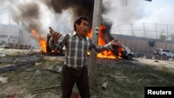 An Afghan man reacts at the site of a blast in Kabul on May 31.