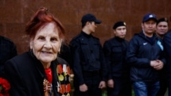 Пожилая женщина рядом с сотрудниками спецназа. Алматы, 9 мая 2019 года.