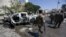 Free Syrian Army fighters inspect damaged cars after a car bomb in Azaz, Syria, in September 2018. 