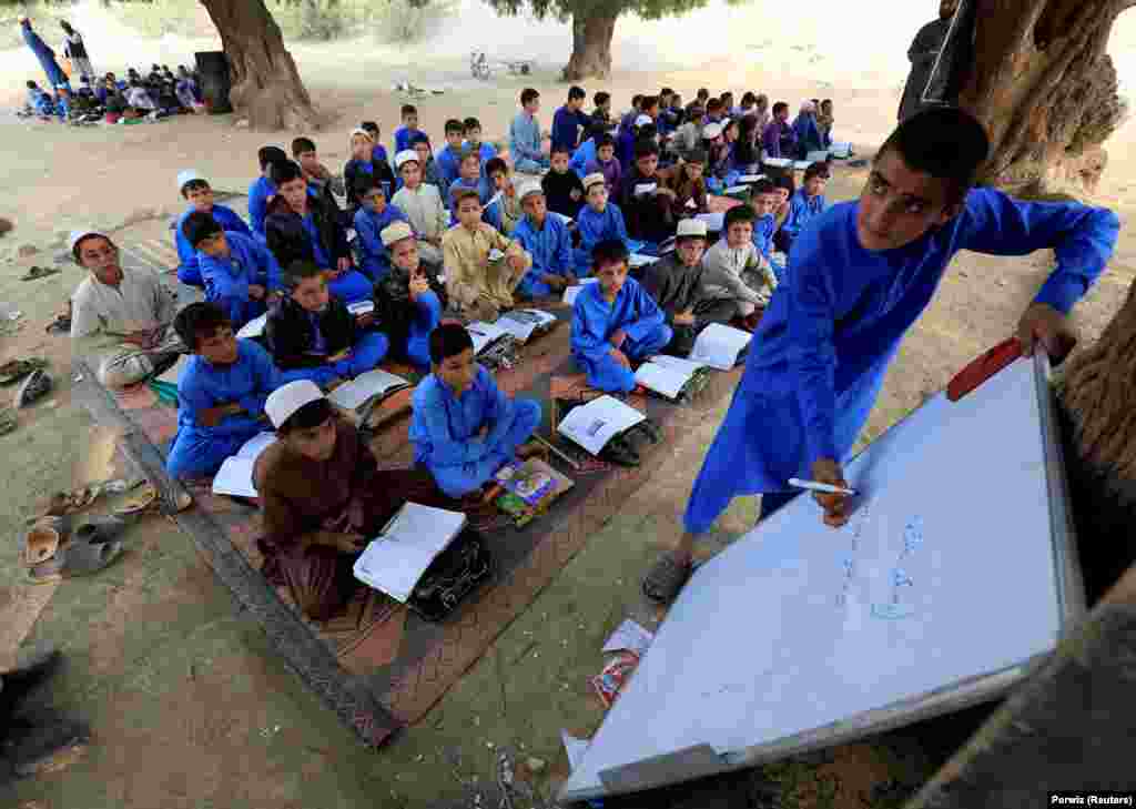 Afghan children study at an open area in the Ghani Khel district of Jalalabad. (Reuters/Parwiz)