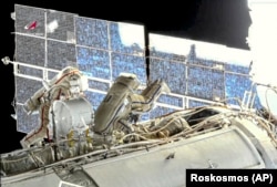 Russian cosmonauts Oleg Novitsky (left) and Pyotr Dubrov, members of the crew to the International Space Station, perform their first spacewalk on June 2.