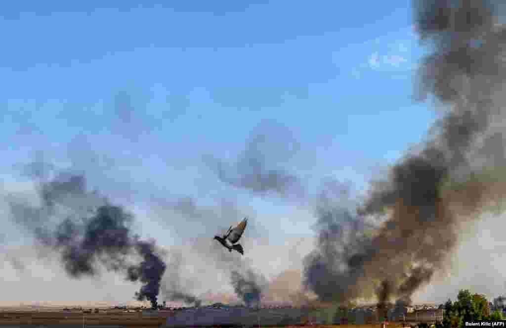 Smoke rises from the Syrian town of Tal Abyad in a picture taken from the Turkish side of the border on October 10. (Bulent Kilic/AFP)