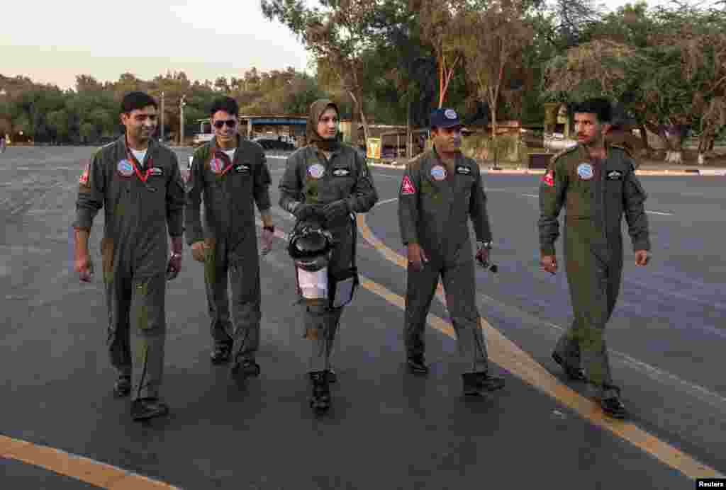 Ayesha Farooq walks with Wing Commander of Squadron 20 Nasim Abbas (second right) and her colleagues toward a Chinese-made F-7PG fighter jet at Mushaf base in Sargodha