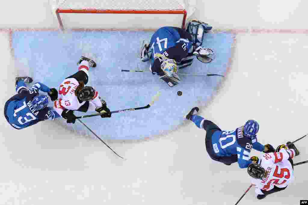 Finland&#39;s goalkeeper Noora Raty makes a save during the women&#39;s ice-hockey Group A match, Switzerland vs Finland, at the Shayba Arena.