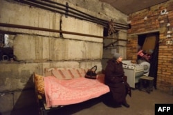 A woman waits in a shelter for shelling to end in Donetsk's Petrovski district on February 4.