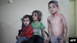 Wounded Syrian children wait to receive treatment at a hospital following a reported air strike on the rebel-held northwestern city of Idlib on September 29.