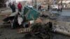 Civilians inspect the aftermath of car bomb attack that exploded in Baghdad earlier this week. Iraq has been gripped by violence in recent months. 