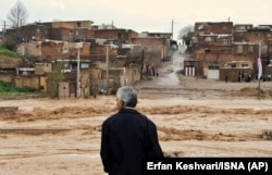 A man watches as floodwaters hit the city of Khorramabad in the western province of Lorestan on April 1.
