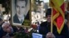 A man holds a portrait of late dictator Nicolae Ceausescu at the tomb of Ceausescu and his wife, Elena, at Ghencea Cemetery in Bucharest on January 26.