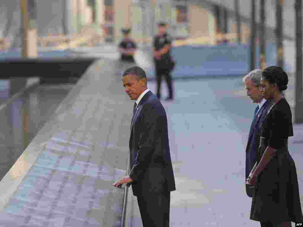 U.S. President Barack Obama, First Lady Michelle Obama, and ex-President George W. Bush visit the North Memorial Pond on the 10th anniversary of the 9/11 attacks at the National September 11 Memorial at Ground Zero in New York City.