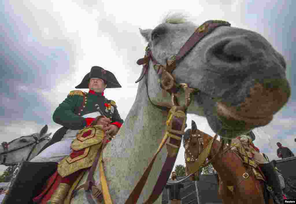 Reenactor Frank Samson, who plays Napoleon, visits the French troops&#39; bivouac camp during bicentennial celebrations for the Battle of Waterloo, in Waterloo, Belgium, on June 19. (Reuters/Yves Herman)