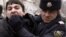 A policeman detains an opposition activist in Baku. The report says Azerbaijan's government unleashed a "new wave of repression and intimidation" in the past year.