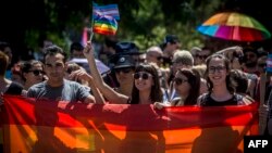 People carry rainbow-colored banners and flags during a gay-pride parade in Belgrade in June.