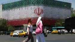 People walk on a street in Tehran on June 14.