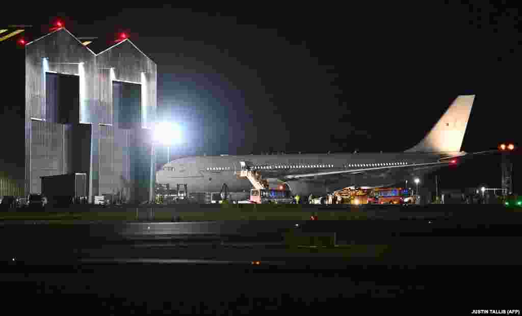 Evacuees from Afghanistan disembark from a British military jet at RAF Brize Norton on August 17.