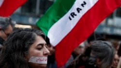 A demonstrator wears a sticker over her mouth with the words "no execution" at a silent march denouncing the Iranian government's deadly crackdown on protesters, in Paris on January 31.